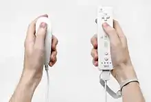 Two types of Wii controllers, one in each hand