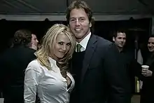 A picture of Willa Ford in a white shirt, posing next to a man