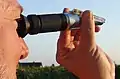 A wine grape grower with refractometer