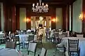 A banquet room with wood and green-paneled walls