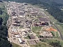 aerial view of a cluster of buildings on a wooded mountainside