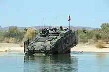 A Royal Danish Army Piranha V infantry fighting vehicle conducts testing at YTC's water fording pit.