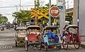 Rickshaws waiting for passengers near the statiom