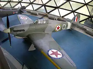 a colour photograph of an aircraft in a museum