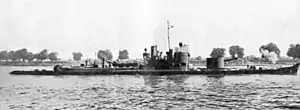 a black and white photograph of a boat on a river